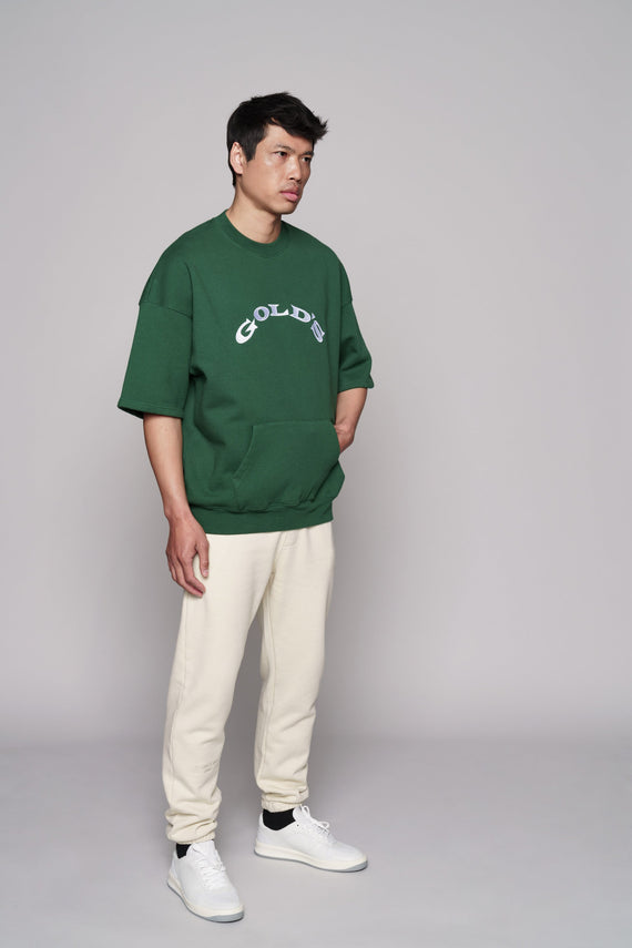 angled view of green short sleeve sweatshirt with white golds text on chest