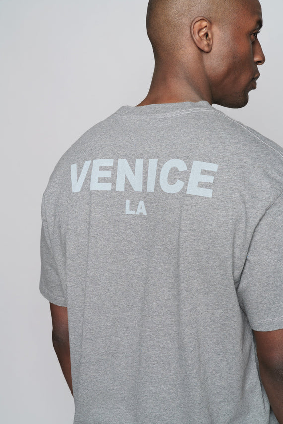 close up of back of grey oversized crew with VENICE LA text